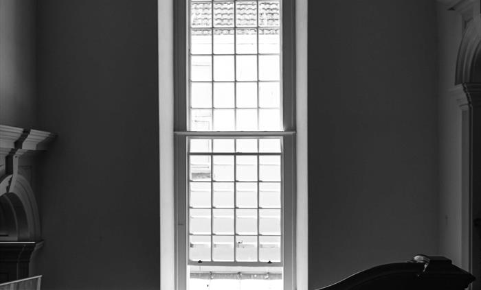 A stunningly tall window lights up the grand staircase, painstakingly reconstructed into its new found Georgian glory.